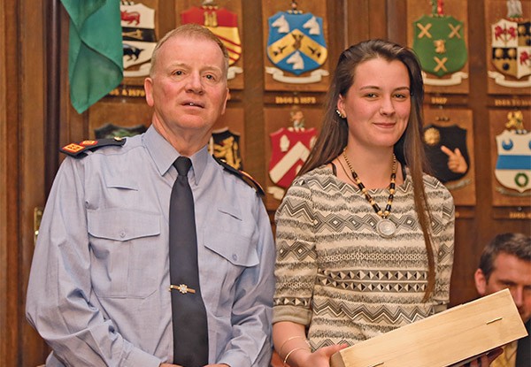 Pictured Above: Superintendent Gerry Delmar presents overall winner of The Spellman Centre School Art Competition award to Nicole Byrne representing Ringsend College. 