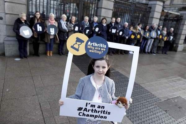 Repro Free: Tuesday 26th January 2016. Arthritis patients launch their Why Are We Waiting? campaign outside Leinster House, Kildare Street, Dublin 2, on Tuesday forming a queue to highlight that 12,000 people  including 400 children  are waiting in pain to see a rheumatology consultant. Arthritis Ireland is calling on the next government to commit to the appointment of just 100 specialist posts to deal with the backlog. whyarewewaiting.ie. Pictured is Colleen White age 9 from Finglas. Picture Jason Clarke.
