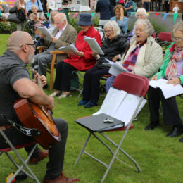 Singing on the lawn, Guitarist Paul Lee and residents in fine voice