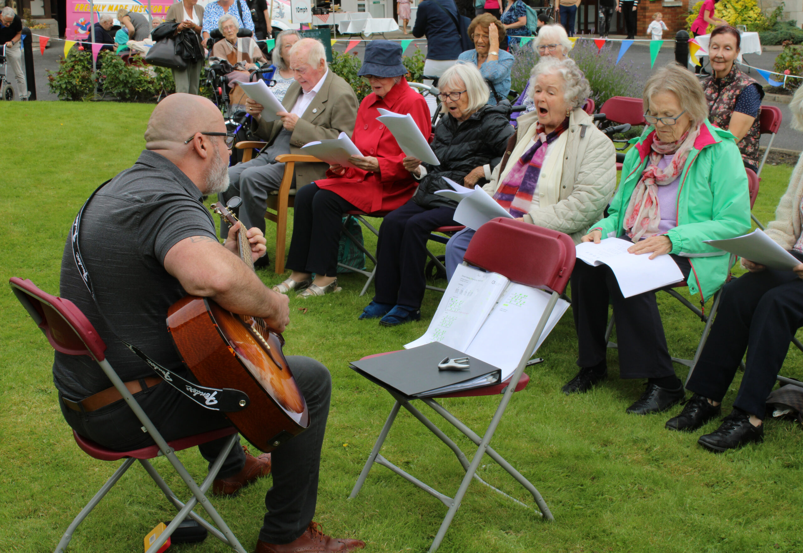 Singing on the lawn, Guitarist Paul Lee and residents in fine voice