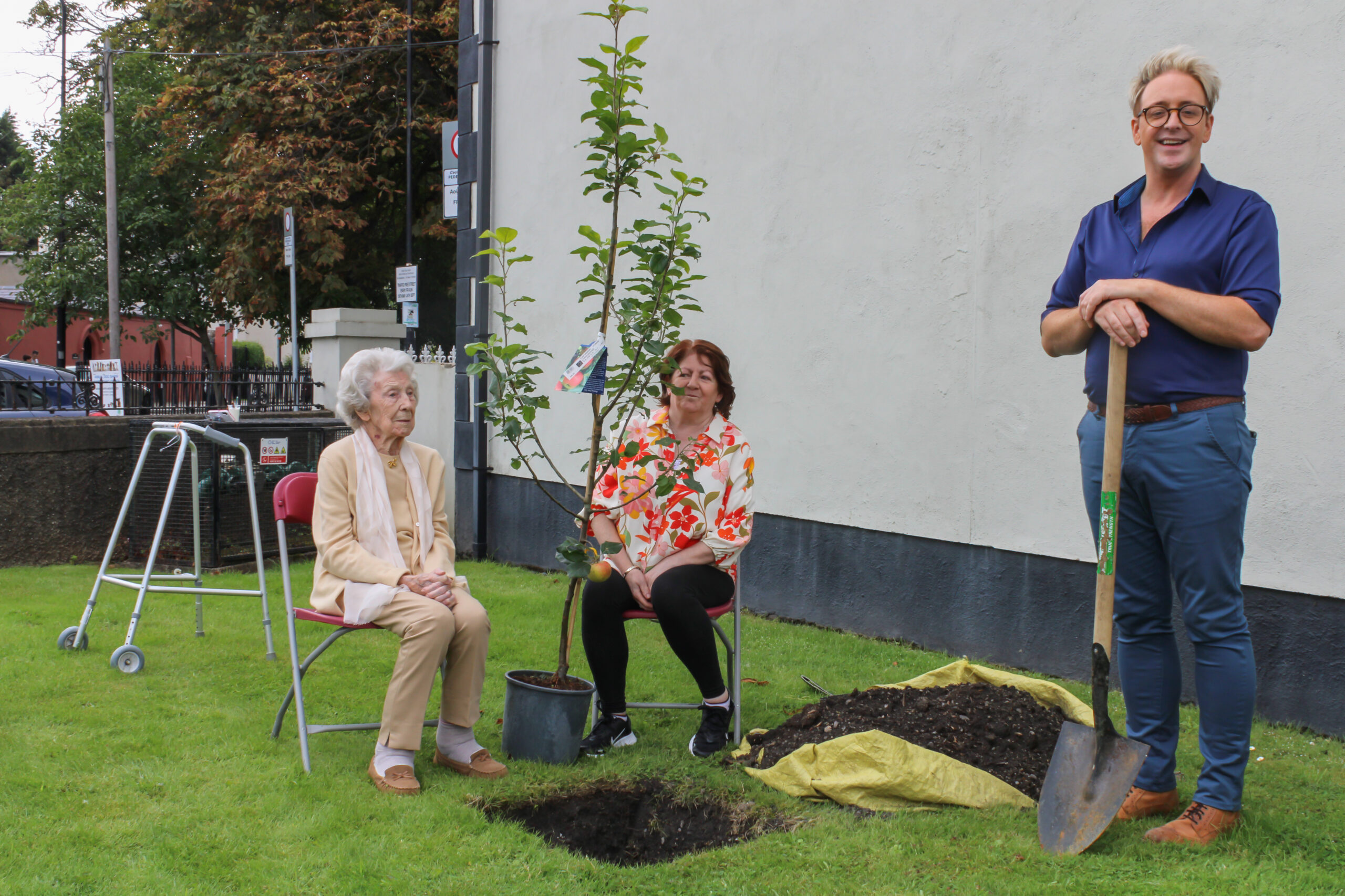 Tree planting ceremony. Colin leaning on his shovel while Dorie and Bernie do all the hard work.